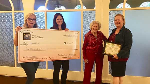 SJ Woman's Club members offer a check to HomeFirst