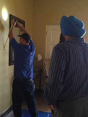 Men installing a security system at the San Jose Woman's Club